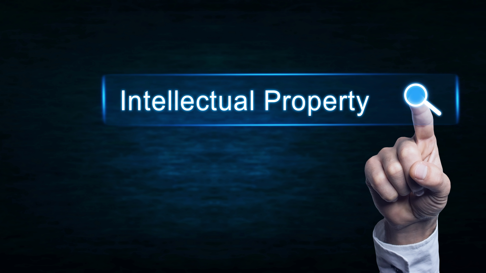 Intellectual property words with a hand pointing towards a search icon