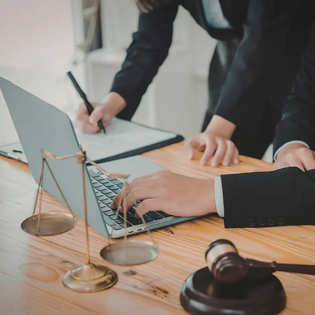 Two IP lawyers reviewing information on a laptop